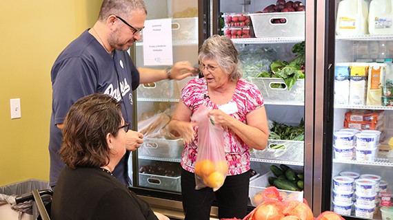 volunteers bagging vegetables in the Corner Market