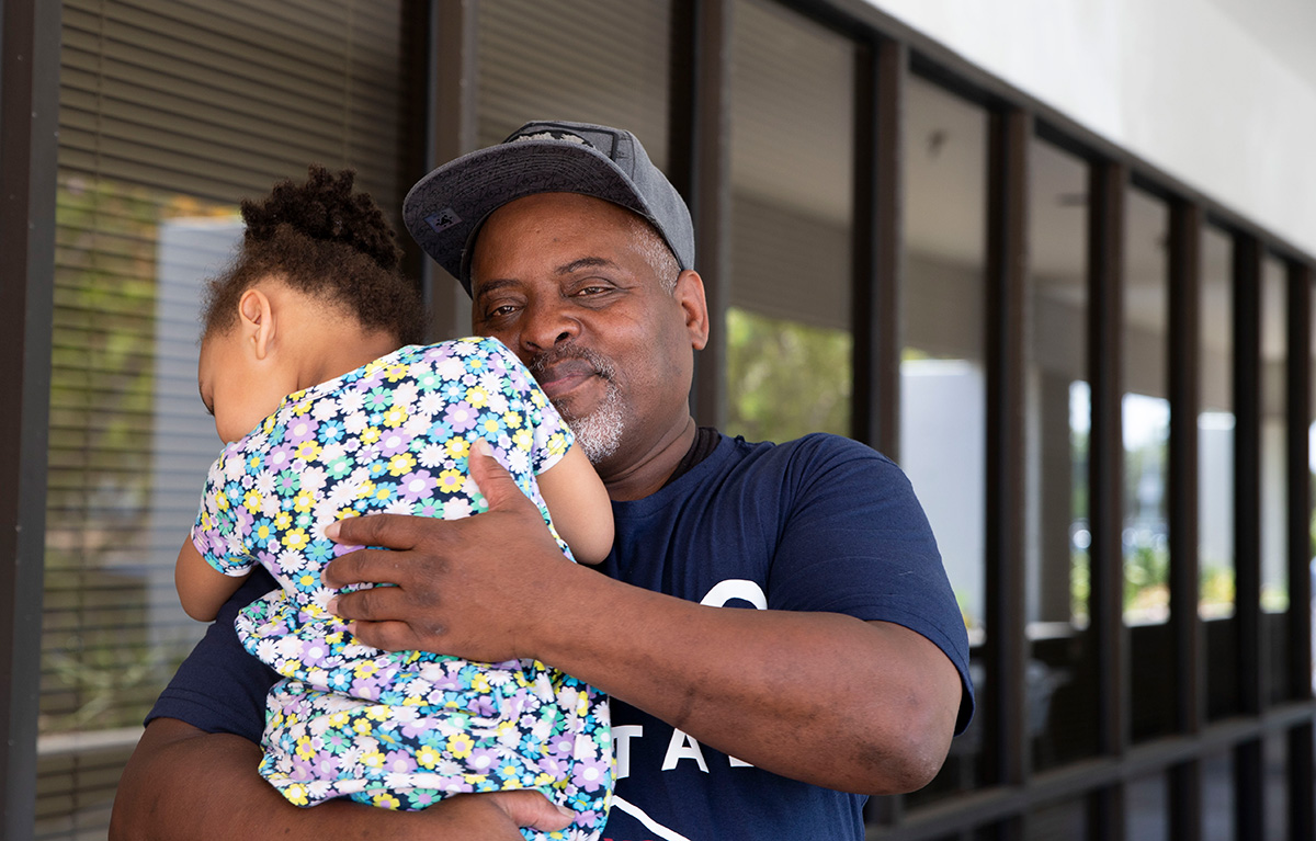 a father holding his daughter in his arms