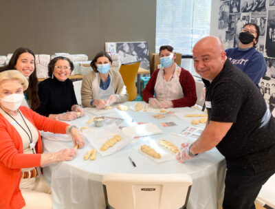 Staff from the Center for Jewish Care teach Team JFS how to make challah for Shabbat San Diego.